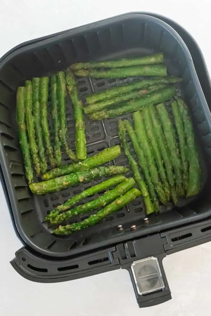 Asparagus in air fryer ready to start cooking