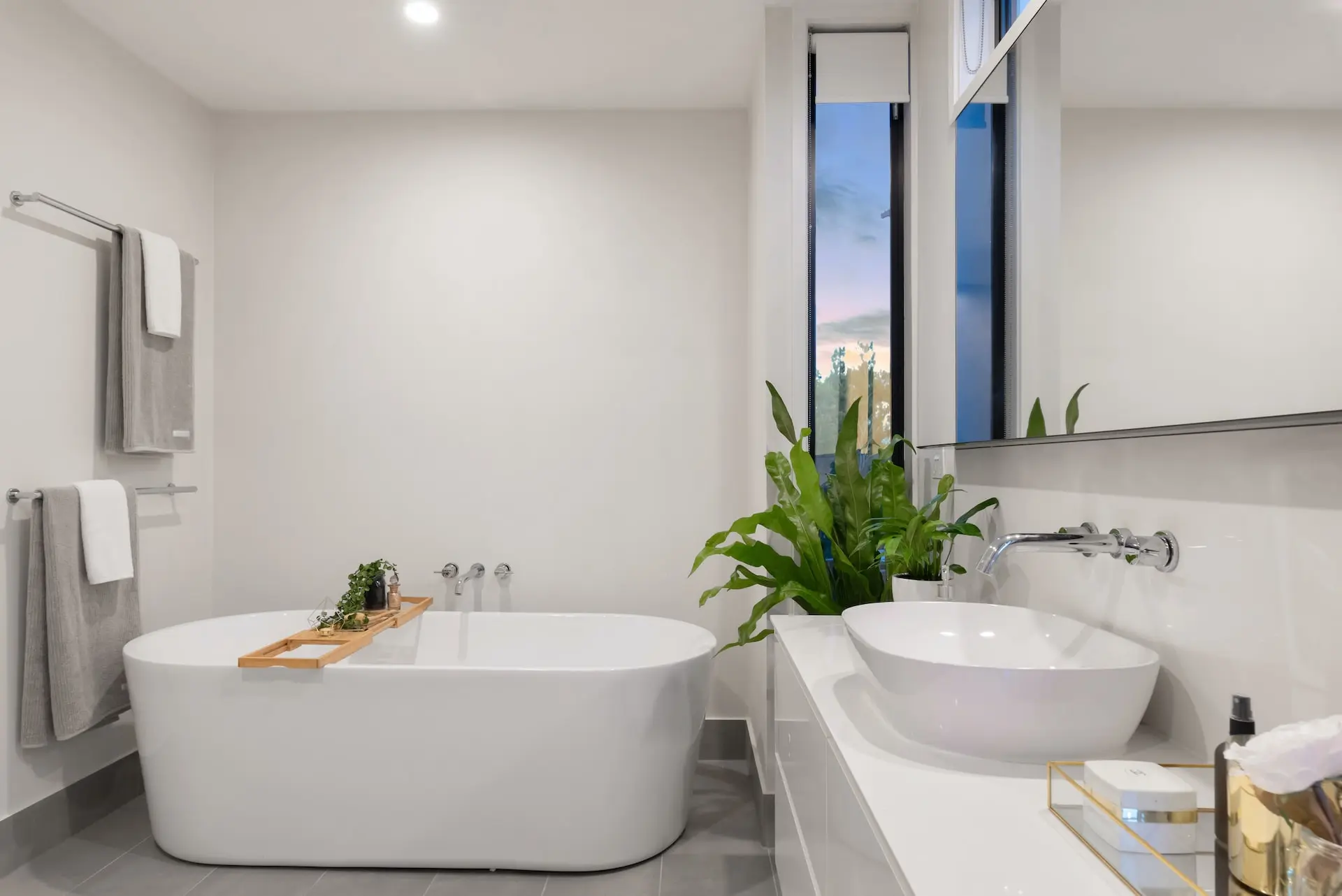 White bathroom with tub and plant