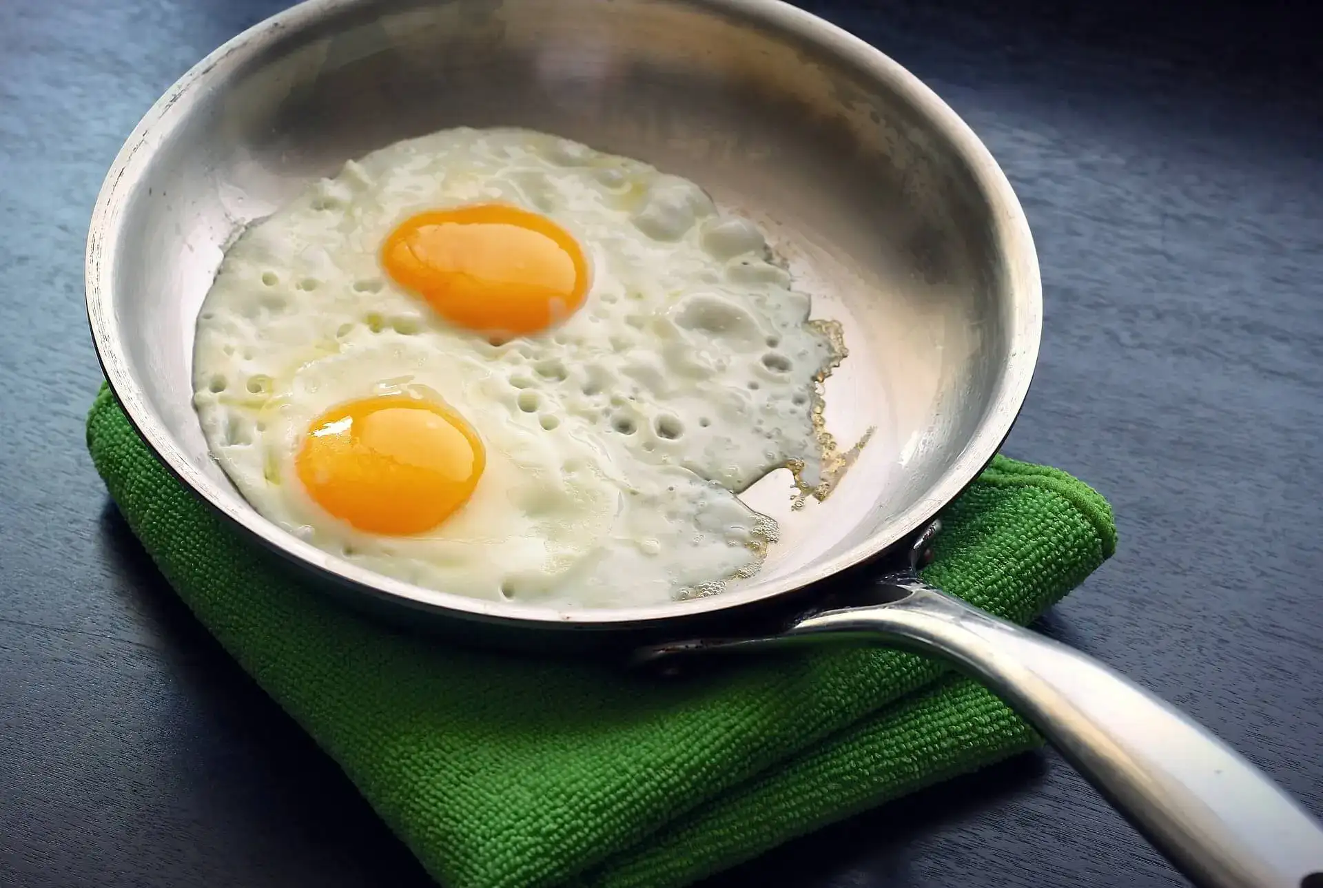 Two eggs in a stainless steel pan