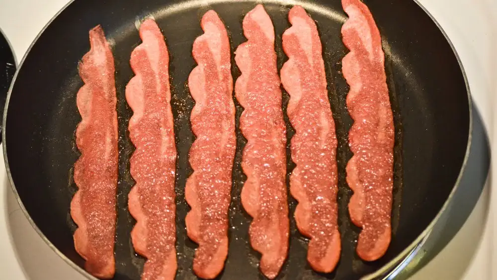 Frying bacon on a stovetop