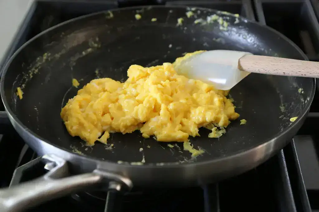 Scrambled eggs in a stainless steel pan