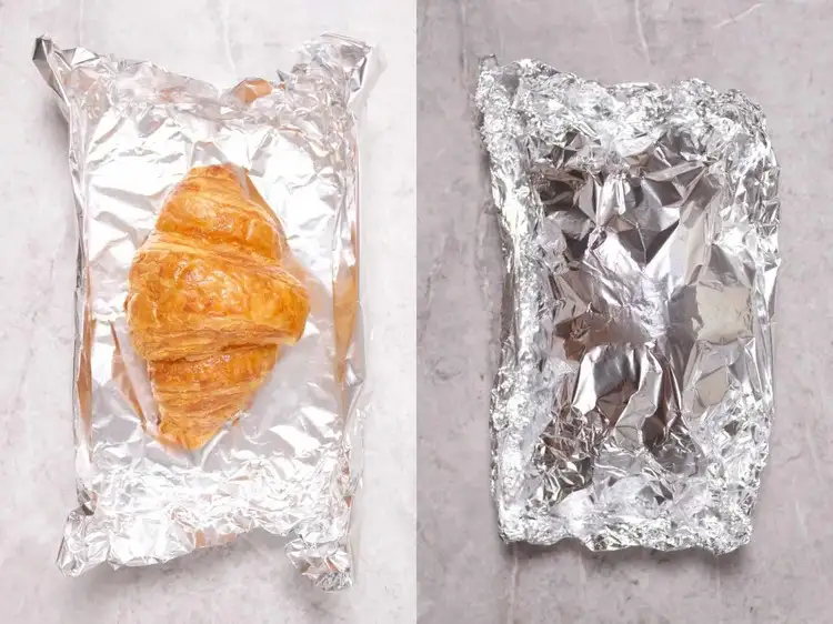Wrapping baked croissants in aluminum foil 