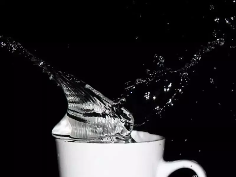 Splashing water in a cup