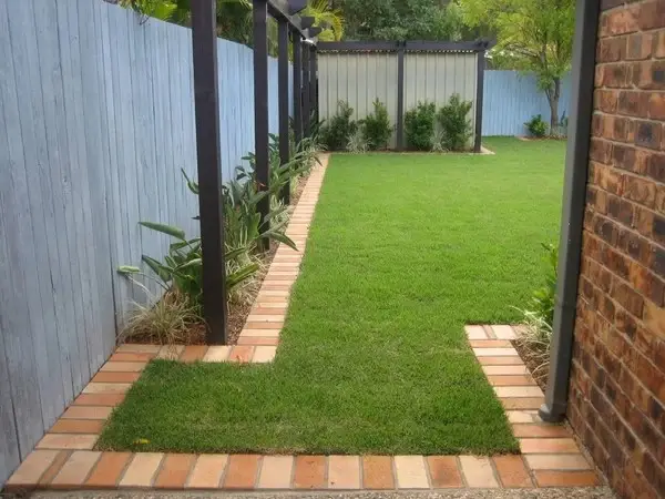 A garden border with a zigzag geometric pattern made from wood