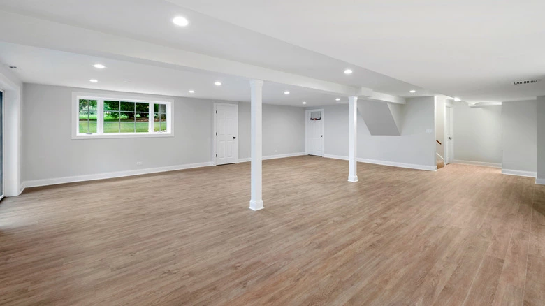 A beautifully remodeled basement with a freshly painted ceiling.