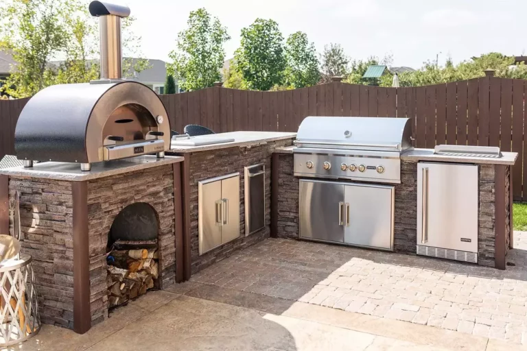 Stunning stone outdoor kitchen with elegant seating arrangement and ambient lighting