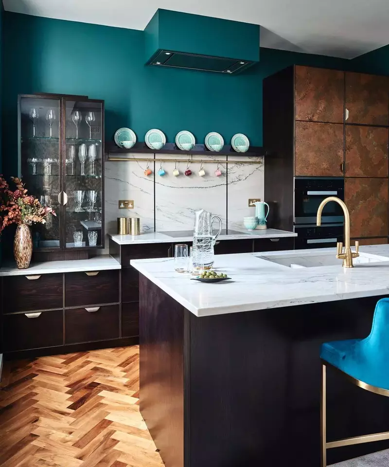 Striking kitchen with dark cabinets and bold, vibrant color accents.