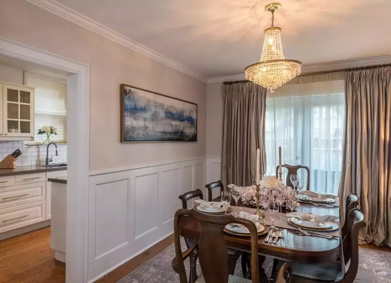 A classic dining room featuring a wainscoting accent wall.
