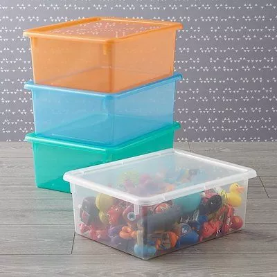 Bright, color-coded toy storage bins in a toddler boy's room.