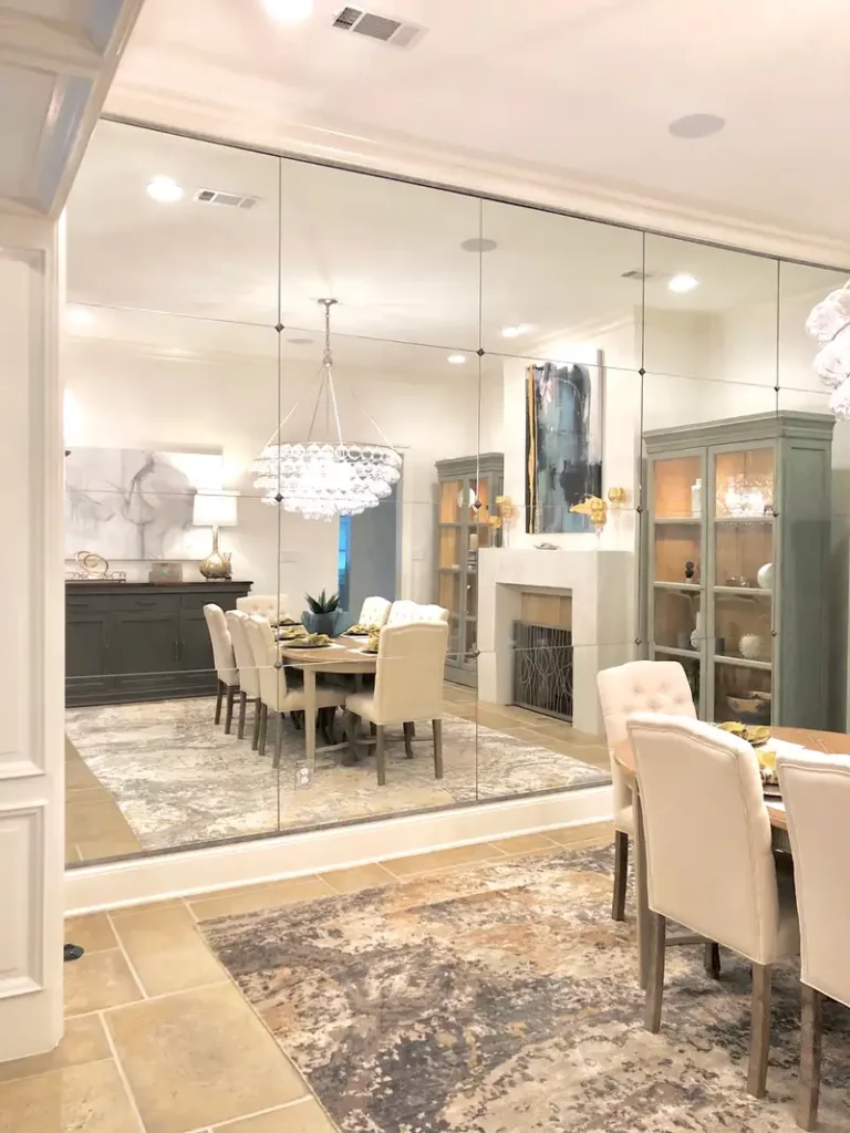 An elegant dining room with a mirrored accent wall to enhance the sense of space.
