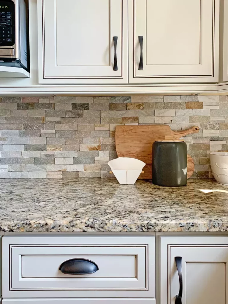Beautiful kitchen showcasing cream wall paint complementing a brown granite countertop
