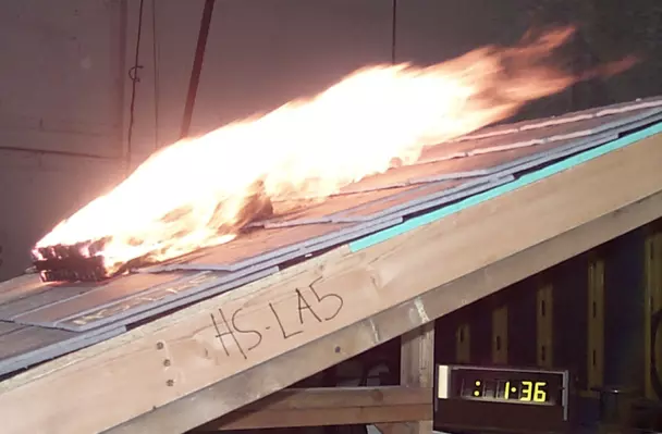 A metal roof demonstrating its fire resistance in a controlled test.