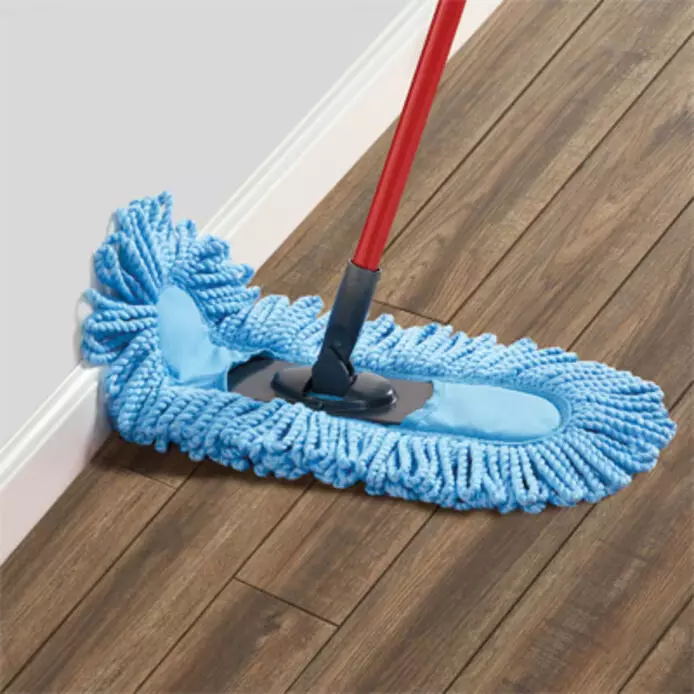 Microfiber dust mop cleaning a hardwood floor, capturing dust and dirt.