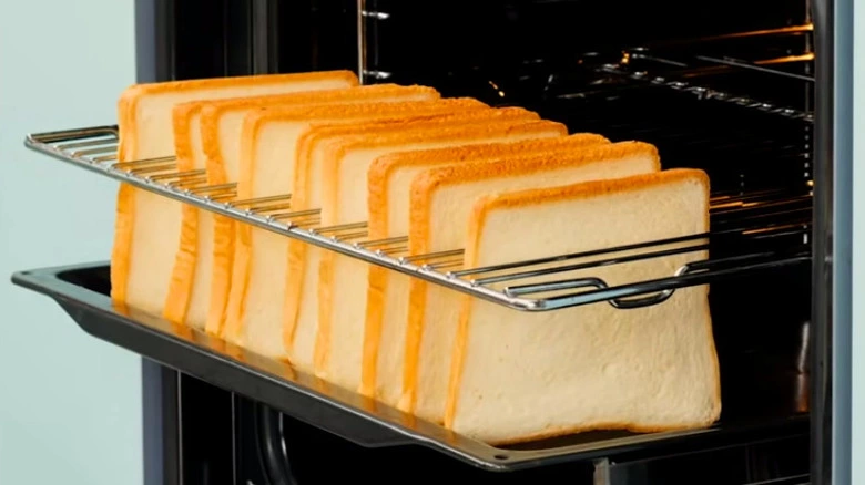 Multiple slices of bread being toasted in the oven for a gathering.