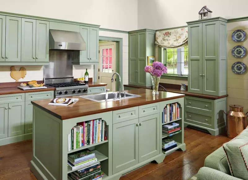 Elegant kitchen with sage green walls perfectly complementing brown granite countertops