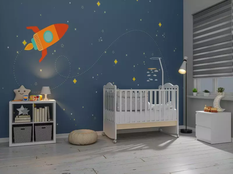 A creatively designed toddler boy's room with a space theme, complete with rocket-shaped shelves and glow-in-the-dark stars.