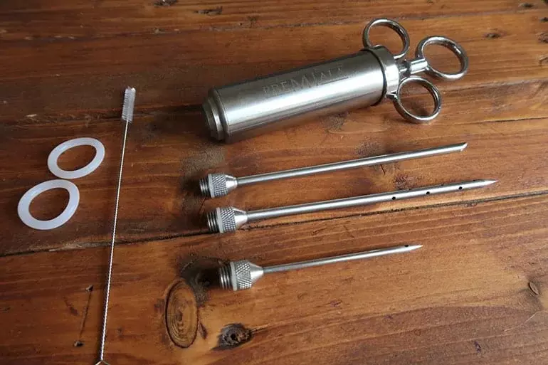 A reliable stainless steel meat injector, ideal for infusing flavors deep into the meat.