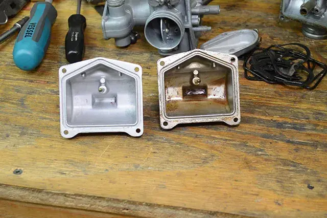 Comparative image of a dirty versus clean lawn mower carburetor.