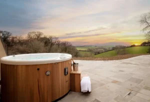 Luxurious hot tub on a deck with sunset view, perfect for relaxation and enjoyment.