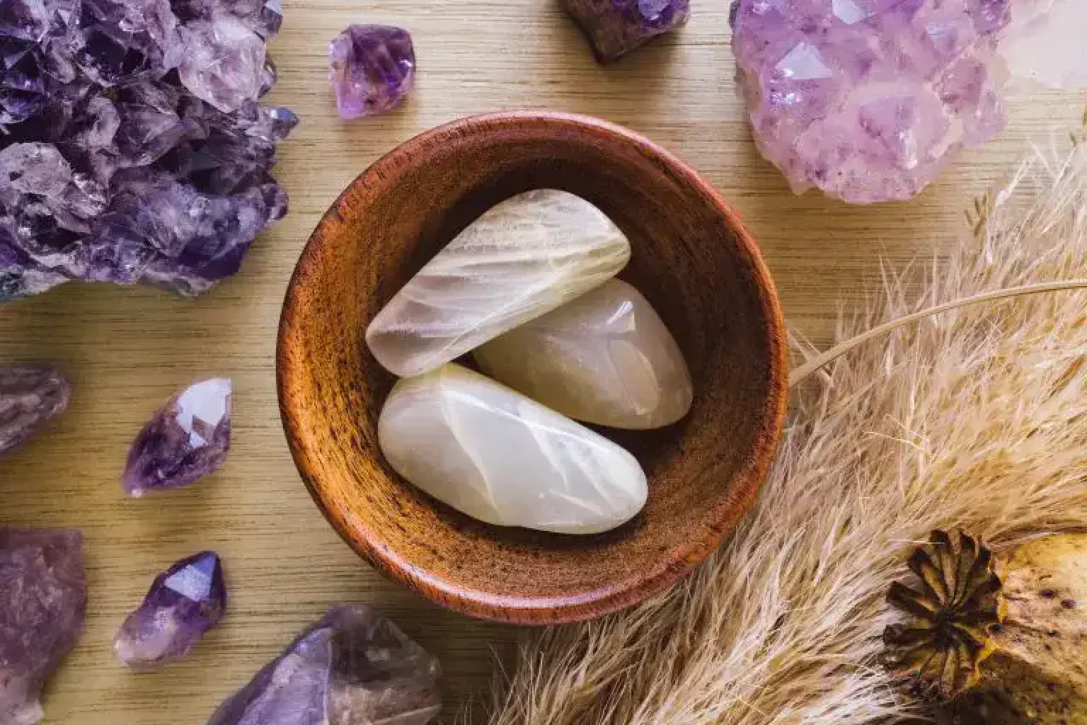 Moonstone crystals in a wooden bowl